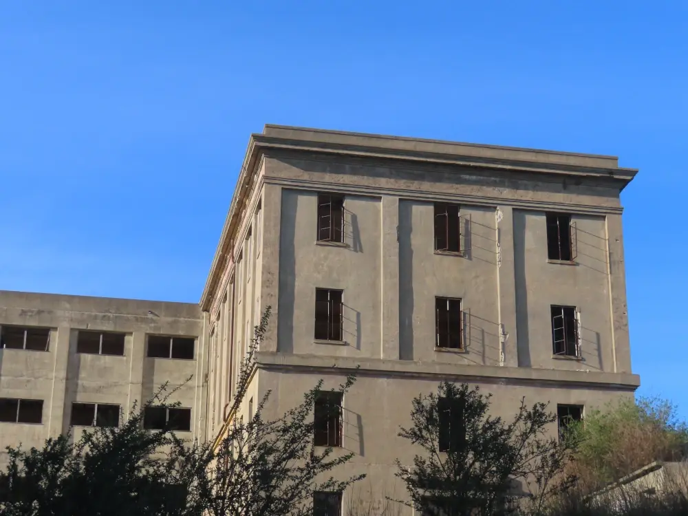 A photo of an abandoned building with empty windows