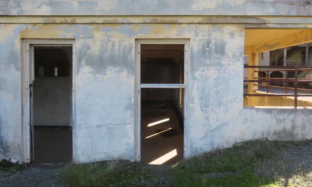 View inside empty building with sunlit patches among the shadow