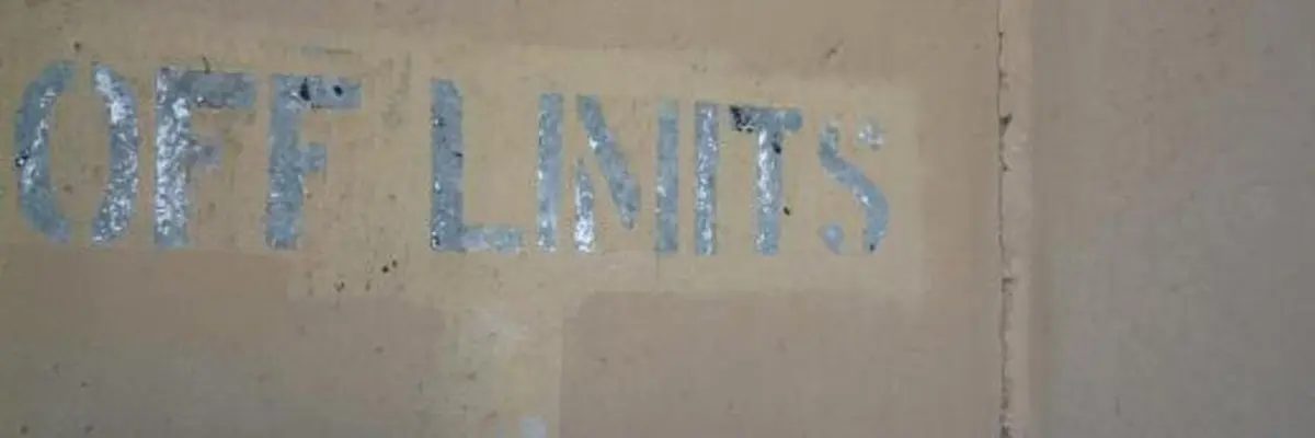 Photo of a concrete wall with the words OFF LIMITS stenciled on.
