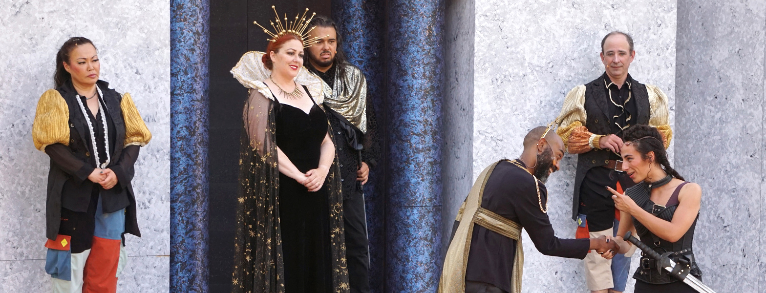 The header image shows the performers, left to right, Eiko Yamamoto as Musician 2, Catherine Luedtke as the Queen, Nathaniel Andalis as Cloten, Ron Chapman as Cymbeline, Brian Herndon as Musician 1, and Mayou Roffé as Caius Lucius in San Francisco Shakespeare Festival’s 2023 Free Shakespeare in the Park production of Cymbeline.