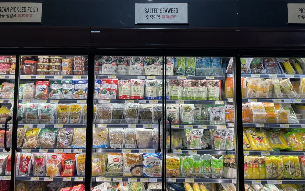 A glass-fronted fridge cabinet displaying a variety of packaged seaweed