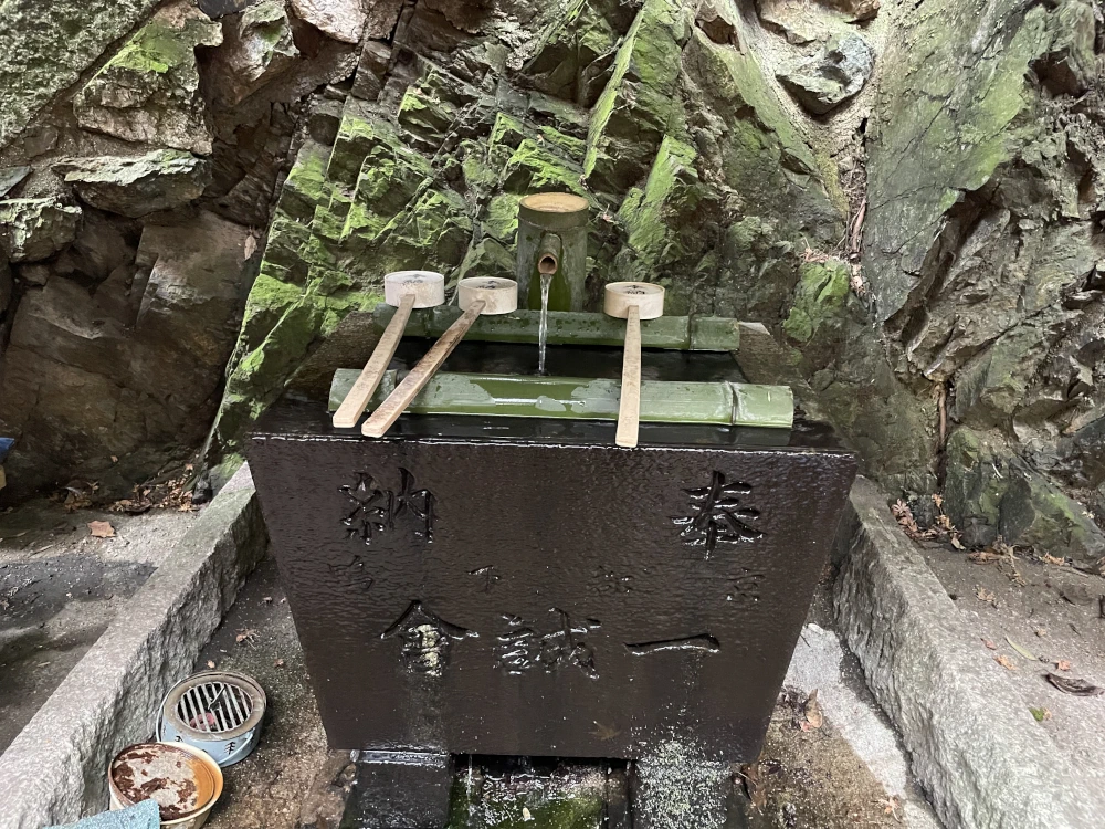 Bamboo dippers rest on a water fount