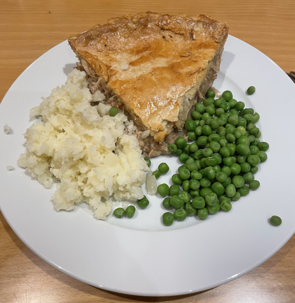 Chicken pie plated with sides